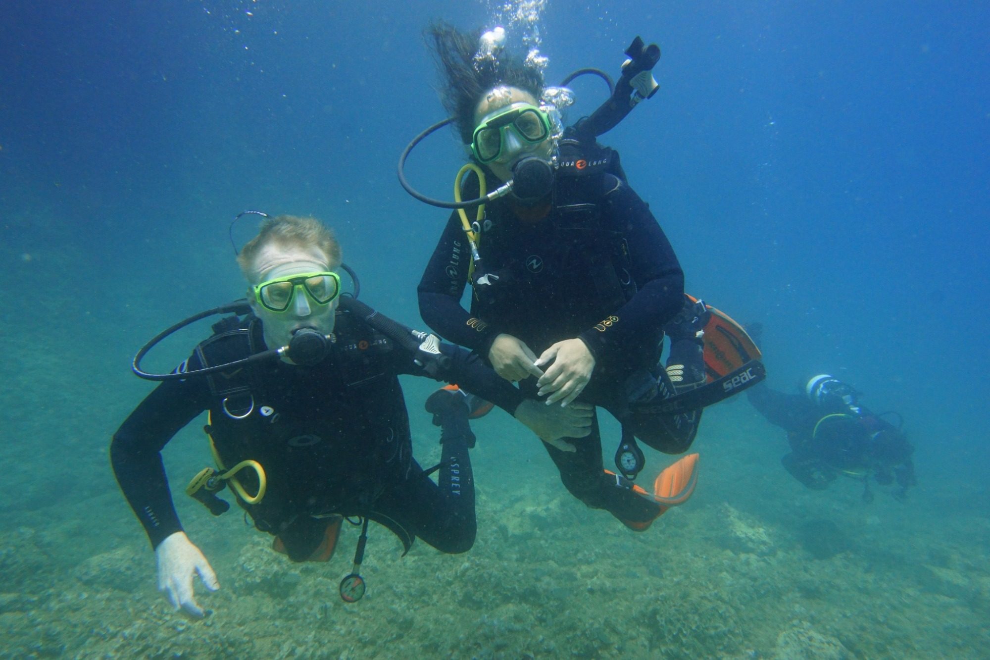 Una foto di un gruppo di subacquei che si immergono in acque cristalline